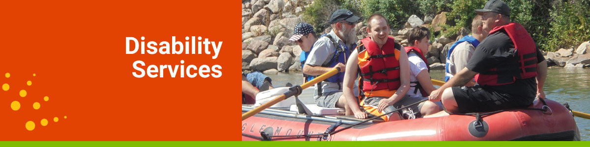 Disability Services webpage header with a group of men floating down a river on a raft.