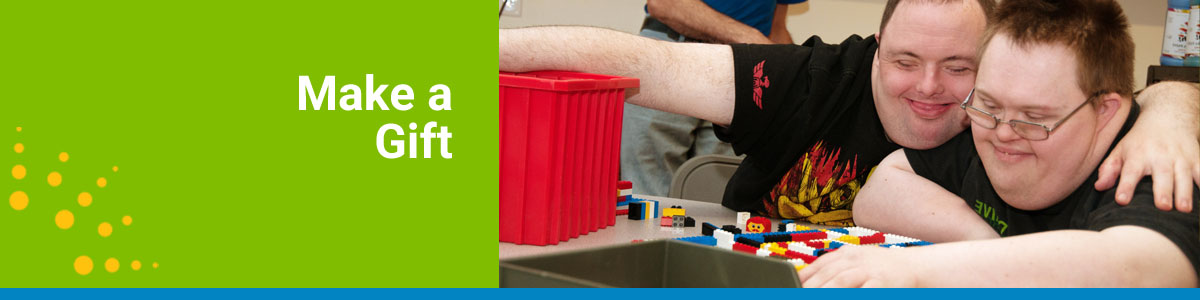 Make a Gift webpage header with two boys smiling while playing with Legos.